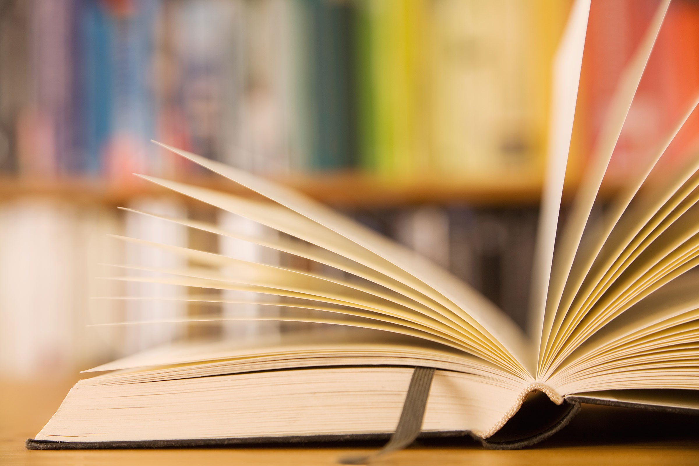 Book laying open on a table in a library