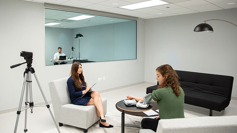 A focus group in which someone is using a medical device and another person is taking notes