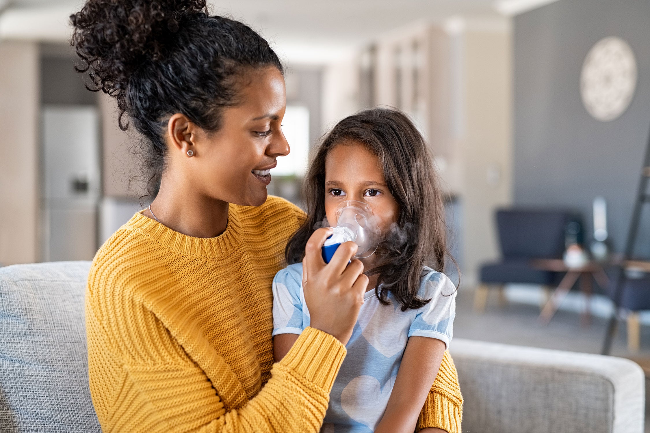 Person giving a child oxygen