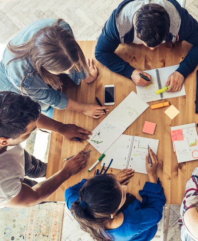 Overhead view of people collaborating at a table