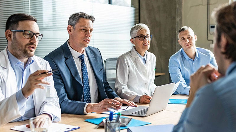 Meeting between doctors and business colleagues