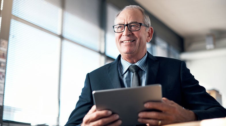 Person in a suit holding a tablet