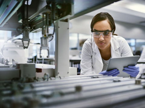 Person in a lab inspecting lab equipment