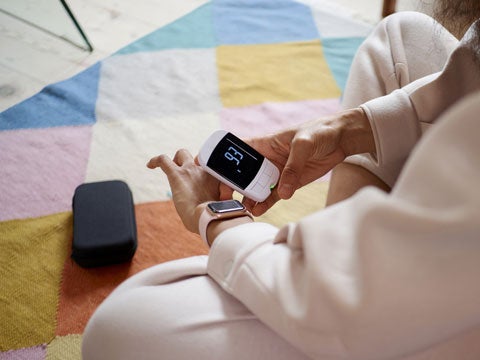 Person using a digital device to check their blood sugar