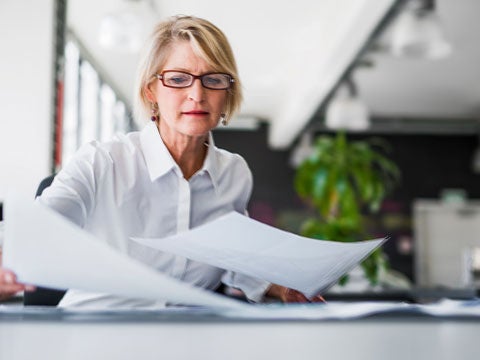 Person laying out papers on a table