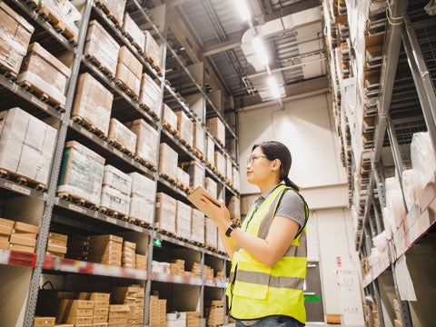 Person in a warehouse taking inventory