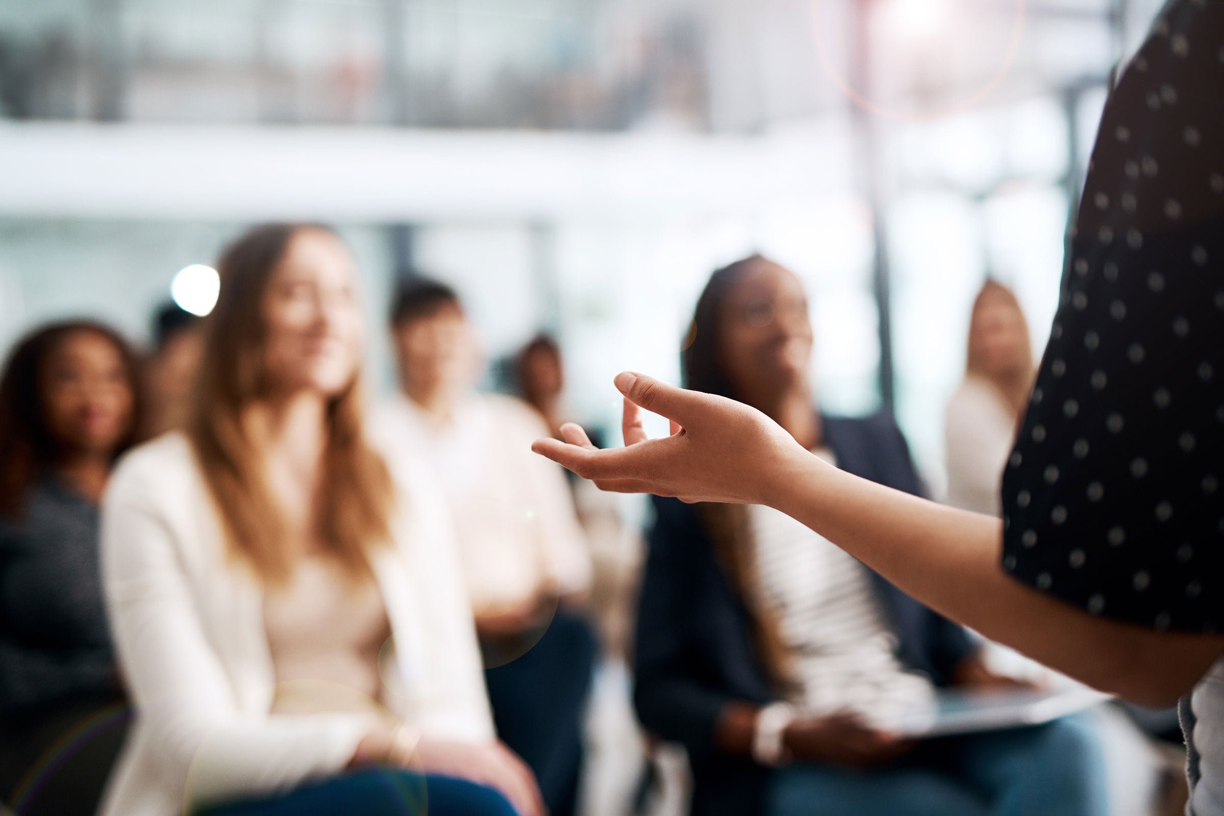 Person speaking in front of an audience