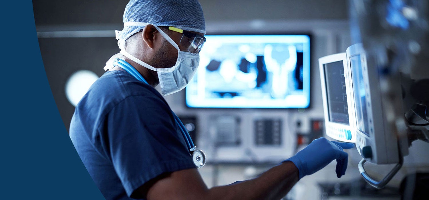 Surgeon looking at a health monitor