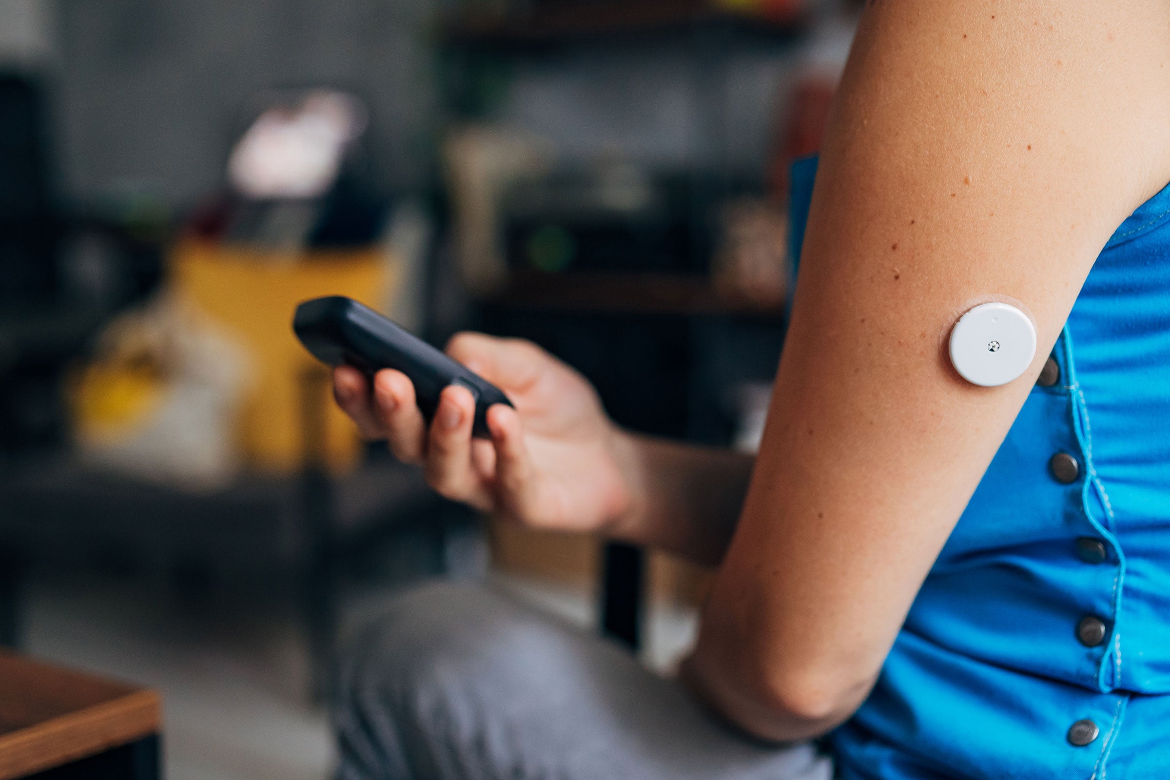 Person testing their blood sugar with wireless medical device
