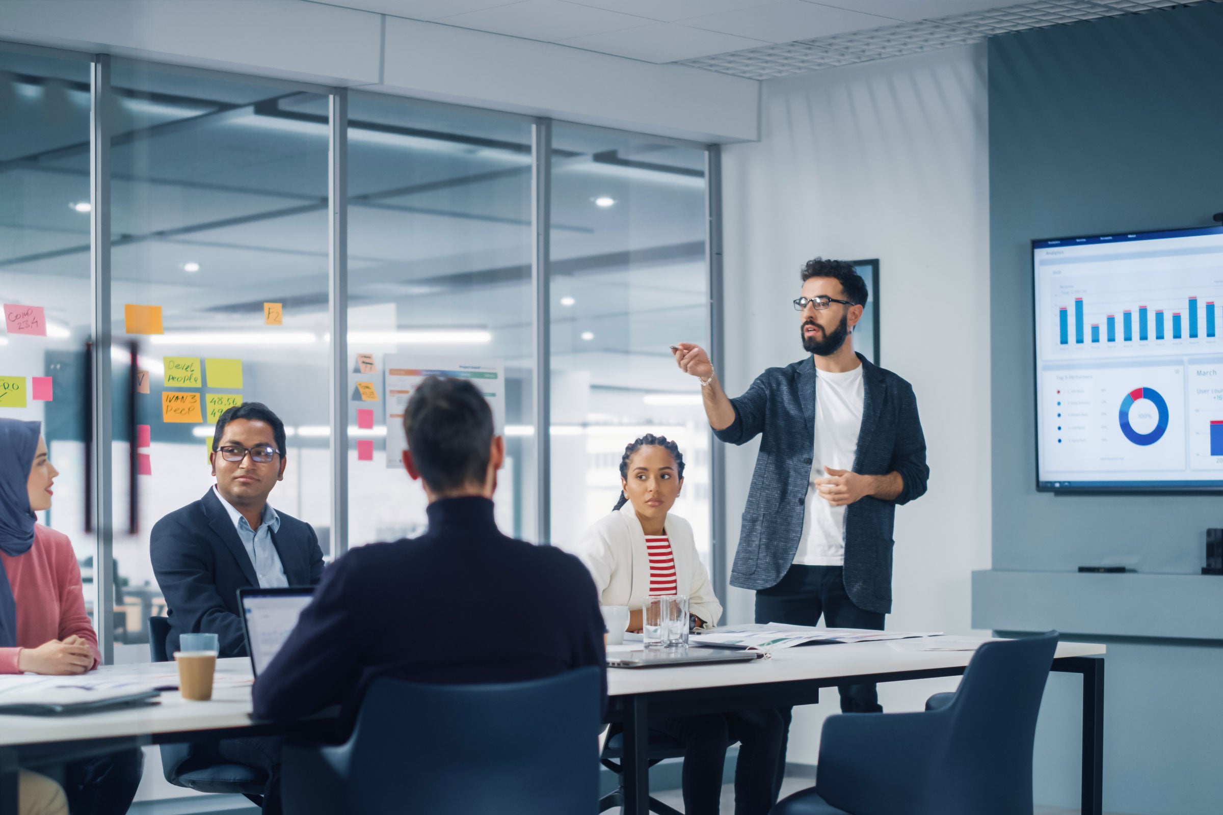 Meeting in a conference room to discuss metrics