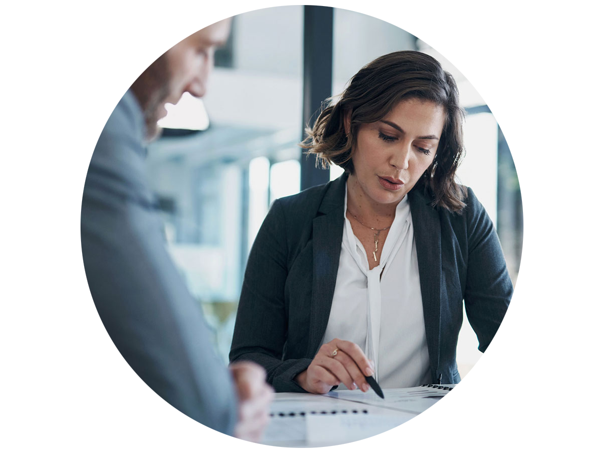 Two business colleagues discussing regulations while looking at documents