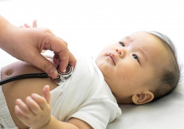 Doctor listening to baby's heart