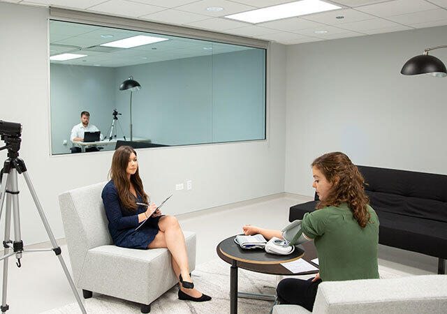 A focus group in which someone is using a medical device and another person is taking notes
