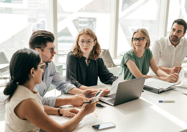 Group of colleagues having a meeting in a contemporary office setting