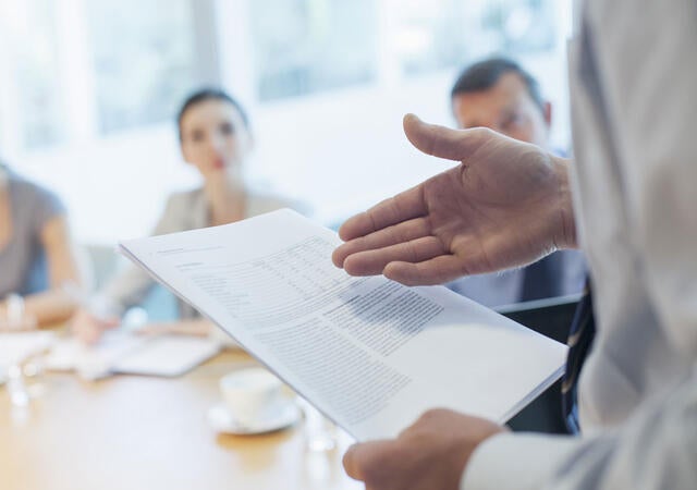 Lawyer presenting new legislation to a group of people in a meeting