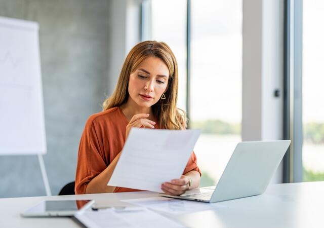 Person in a meeting room reviewing documents