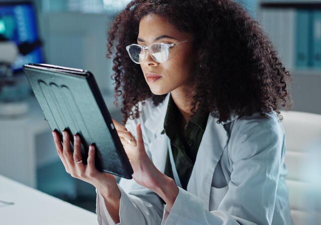 Medical professional reviewing results on a tablet