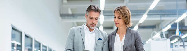 Two people walking and having a discussion in a lab