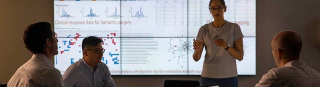 Meeting in front of a large information device about universal detection of genes in a specific biological sample.