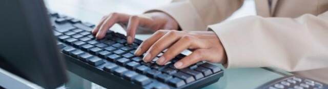 Hands typing on a keyboard.