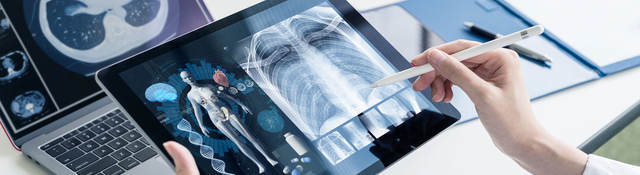 A person is reviewing x-rays on a mobile device