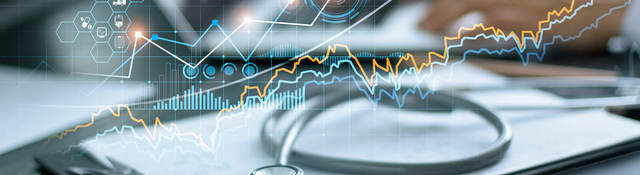 Charts and graphs superimposed over an a medical desk