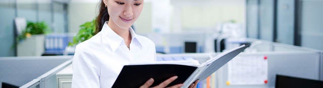 Person looking at documents in a binder