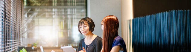 Two women comparing notes in an office