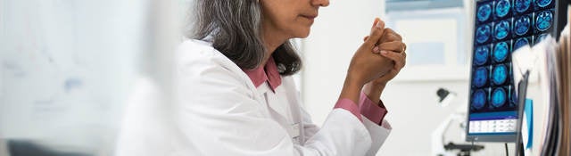 Doctor reviewing x-rays on a computer