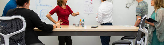 People gathered around a whiteboard having a meeting