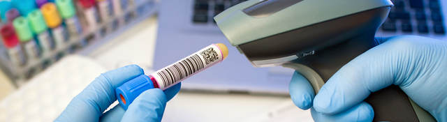 Person scanning a QR code on a test tube