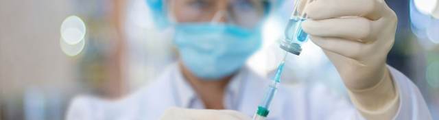 Nurse filling a syringe