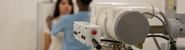 Nurse aligning a patient in order to take an x-ray