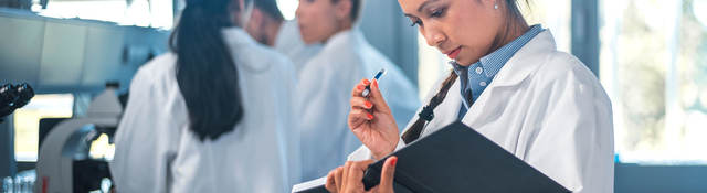 Medical doctor reviewing notes in a book