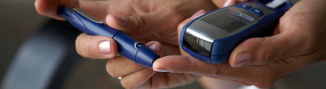 Person using a machine to check their blood sugar