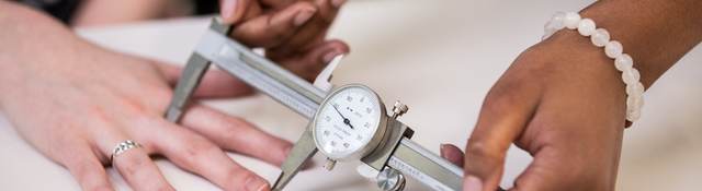 Doctor measuring the length of a patient's finger