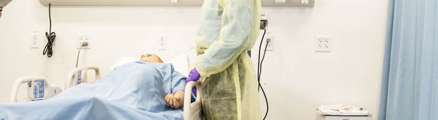 Doctor standing over patient in a hospital