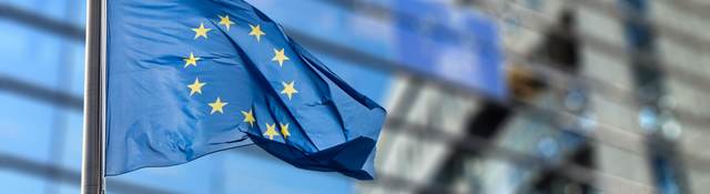 EU flag waving in front of a building