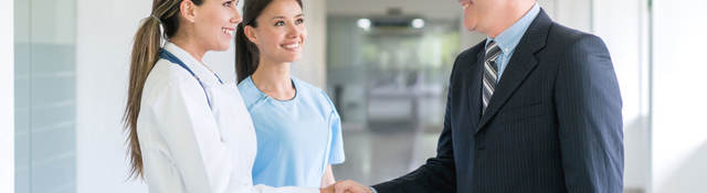 Doctor shaking a person's hand inside a hospital