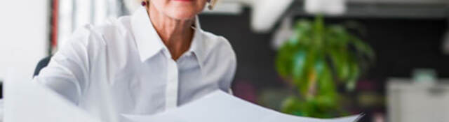 Person laying out papers on a table