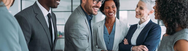 Group of business professionals greeting each other and shaking hands 
