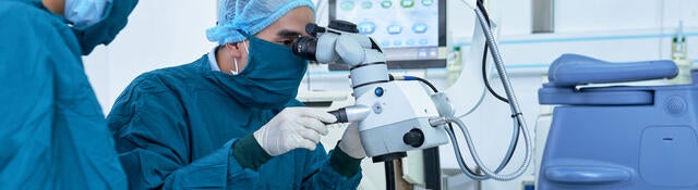 Two ophthalmologists performing operation on a patient's eyes