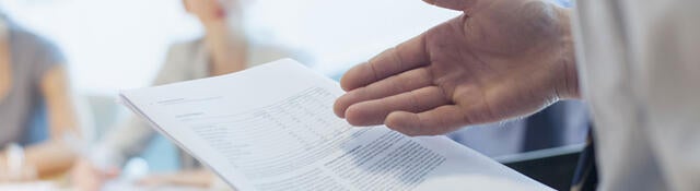 Lawyer presenting new legislation to a group of people in a meeting