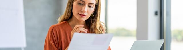 Person in a meeting room reviewing documents