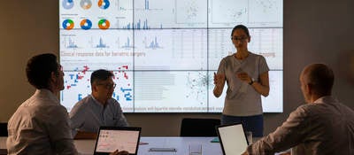 Meeting in front of a large information device about universal detection of genes in a specific biological sample.