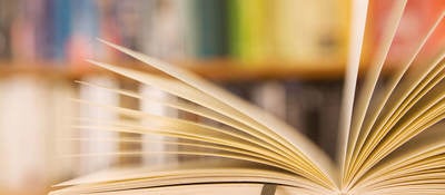 Book laying open on a table in a library