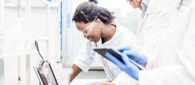 Lab techs working on a laptop