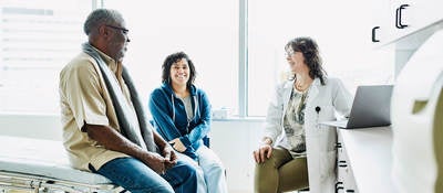 People sitting in a room with a doctor