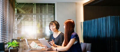 Two women comparing notes in an office