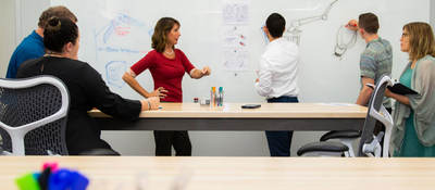 People gathered around a whiteboard having a meeting